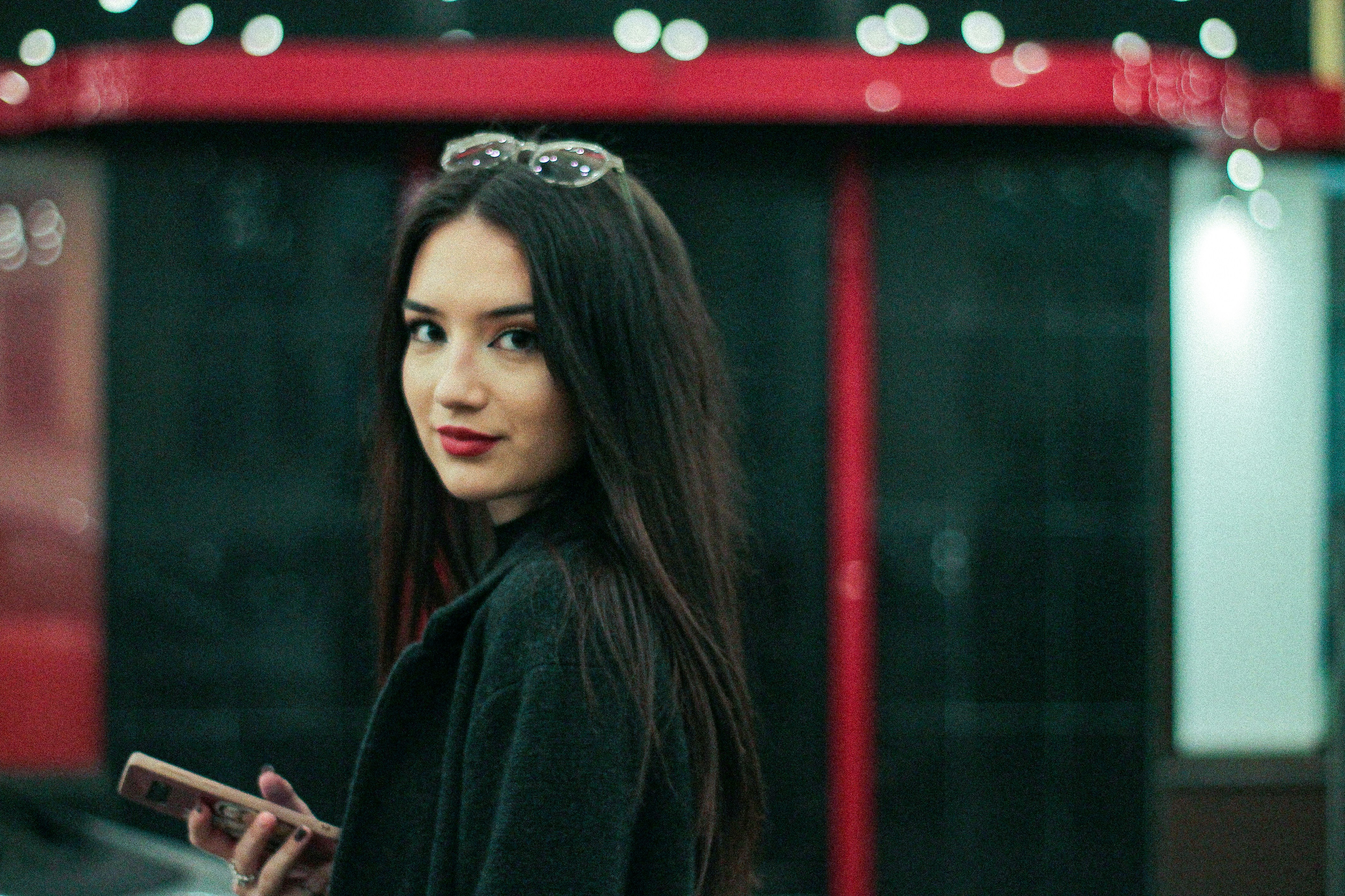 woman in black coat standing