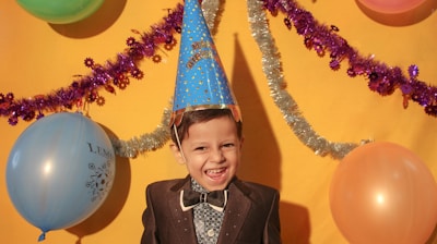 boy in black suit jacket smiling