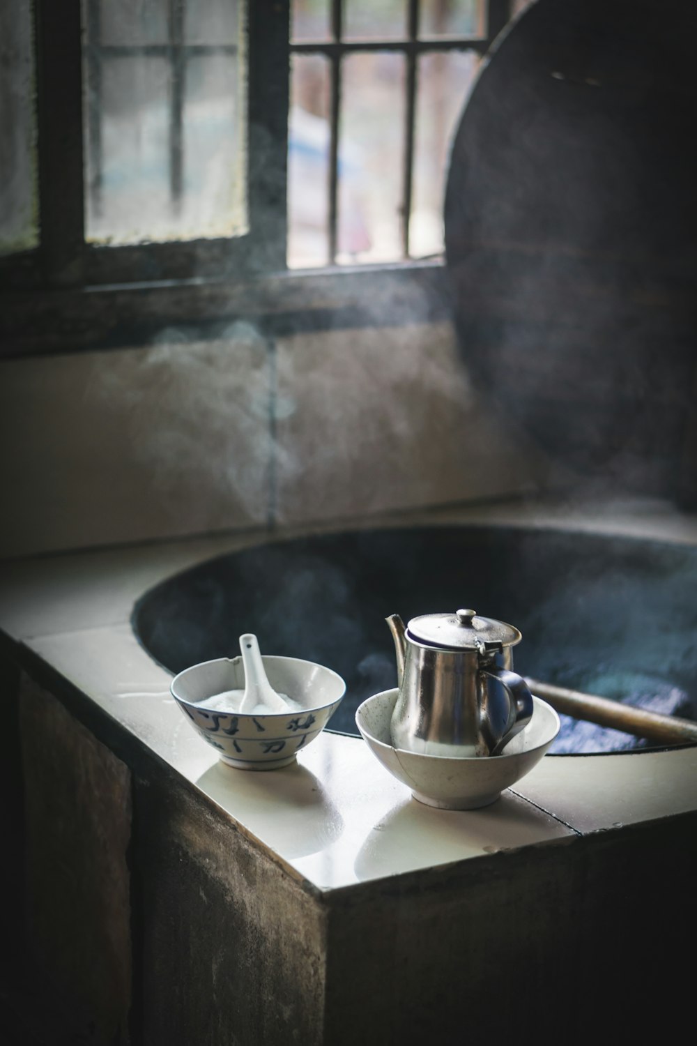 stainless steel teapot on white ceramic bowl