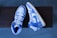 A pair of stylish low-top shoes displayed on a wooden surface.