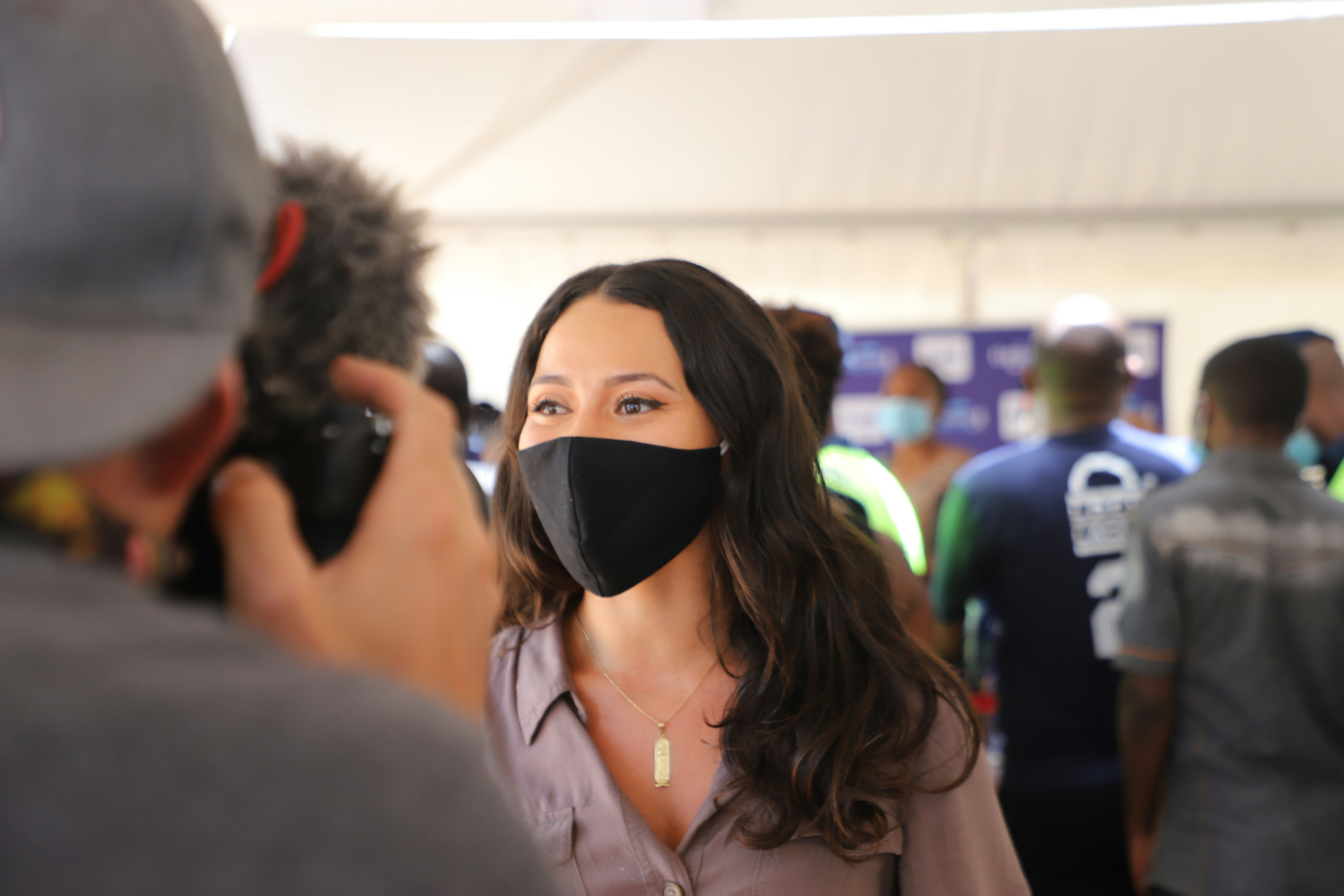 woman in black mask and pink shirt