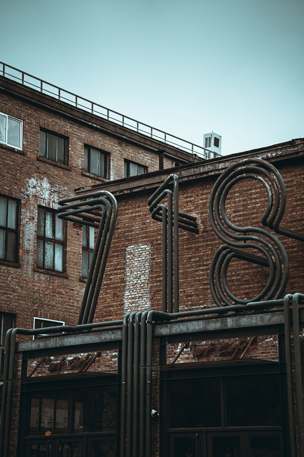 brown brick building with black metal gate