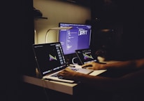 woman in black tank top sitting in front of computer