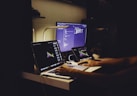 woman in black tank top sitting in front of computer