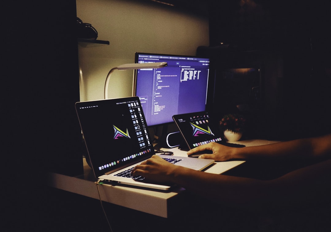 woman in black tank top sitting in front of computer, Work/Study from home setup.