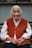 woman in red vest and white dress shirt