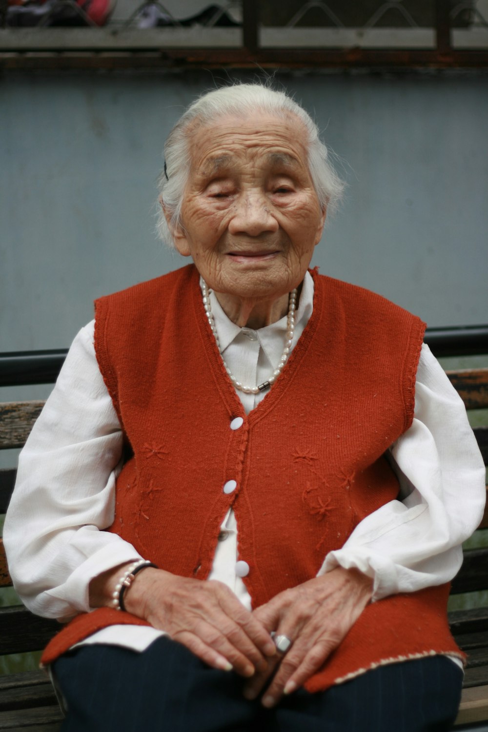 woman in red vest and white dress shirt