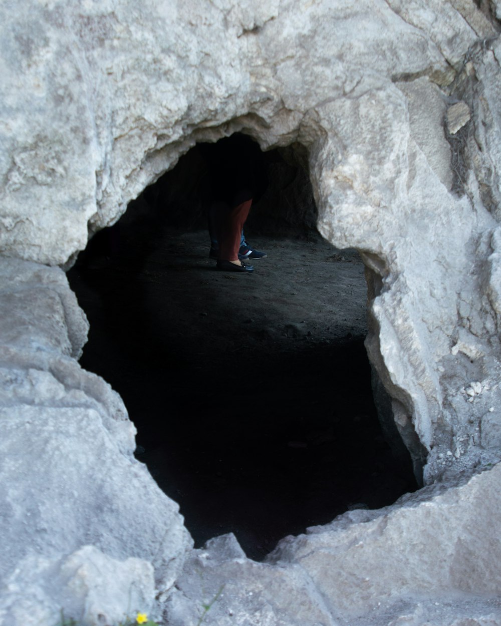 person in black shirt climbing on gray concrete wall