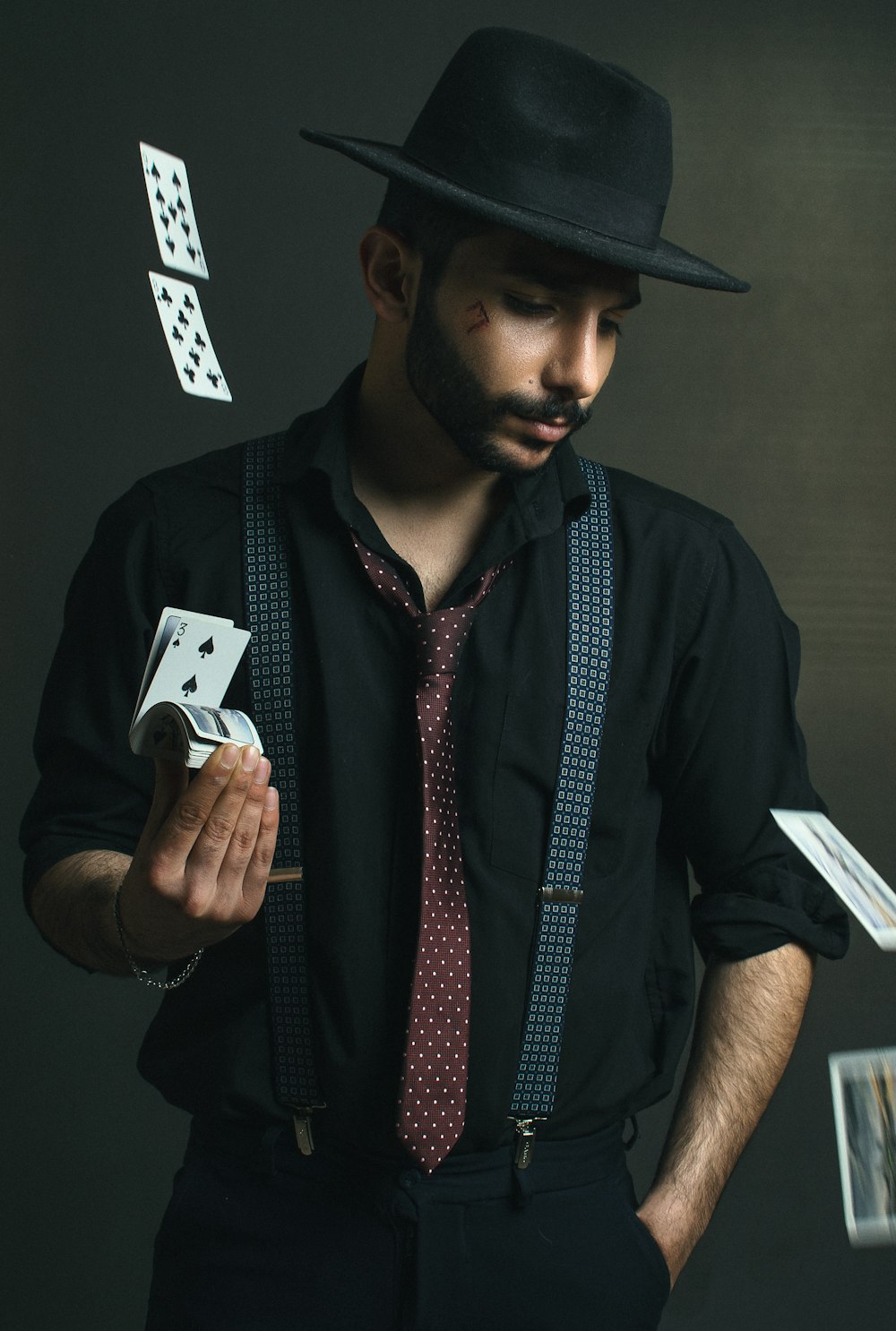 man in black button up shirt holding white smartphone