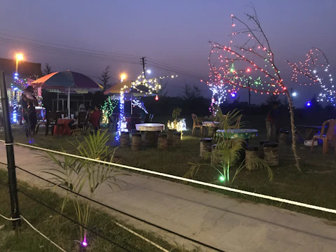 Outdoor party setup with colorful lights and comfortable seating.