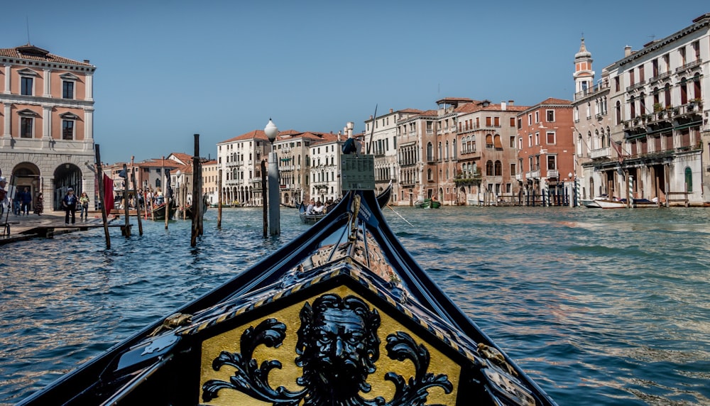 boat on water near buildings during daytime