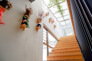 View of a stairwell with freshly installed white ceiling cladding that brightens the space.