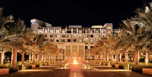 A stunning view of JW Marriott Hotel’s grand entrance bathed in warm evening light.