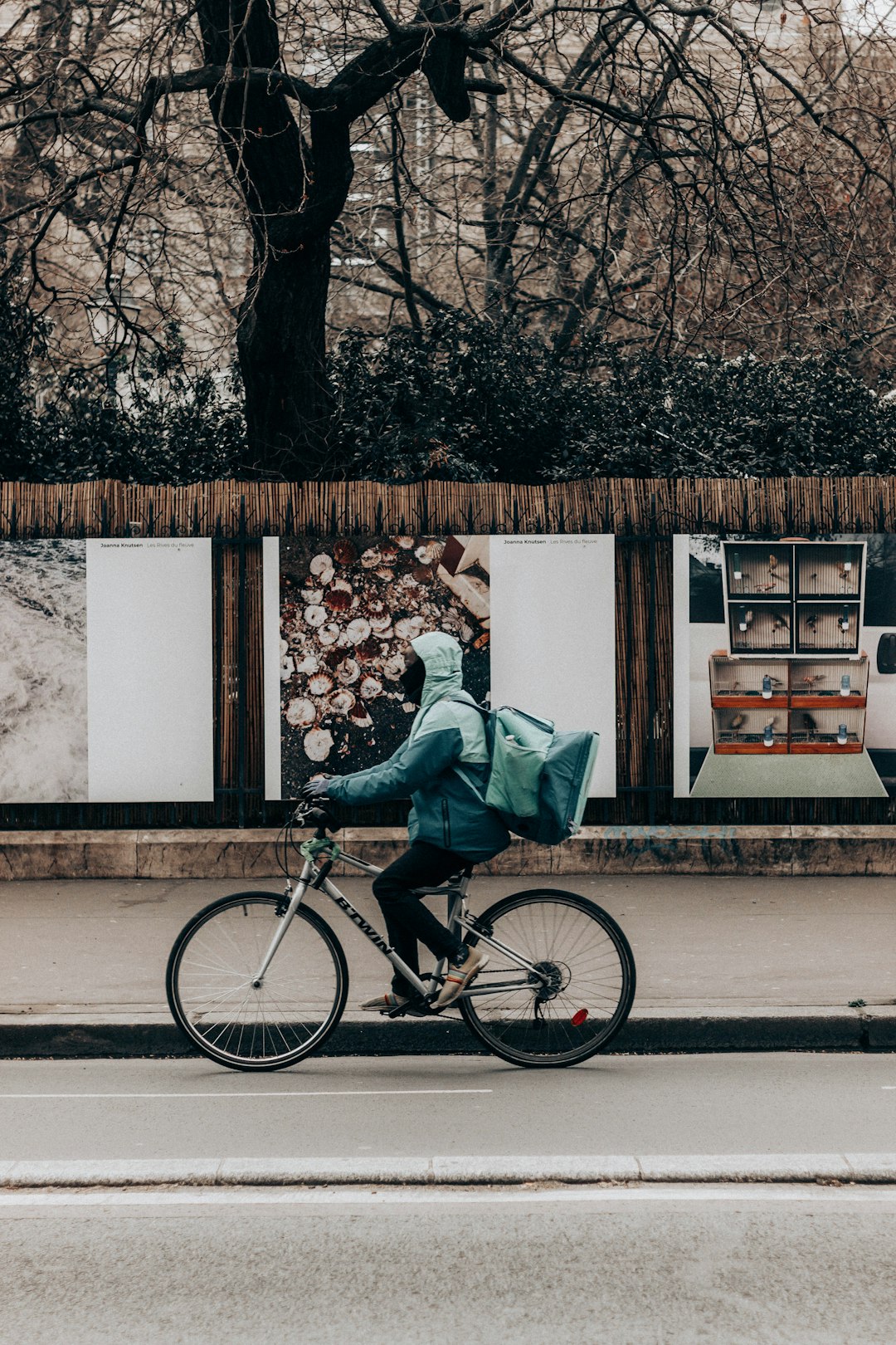 man in blue denim jeans and white shirt sitting on black city bike