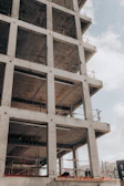 brown concrete building under white clouds during daytime