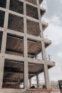 brown concrete building under white clouds during daytime