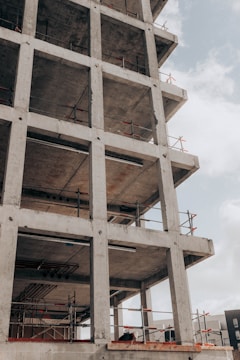 brown concrete building under white clouds during daytime