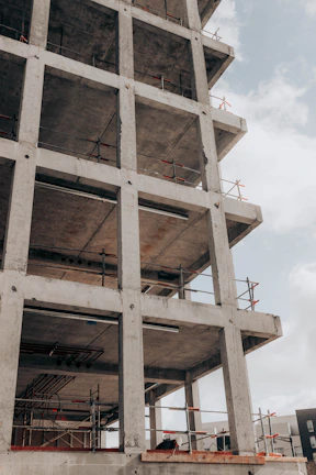 brown concrete building under white clouds during daytime