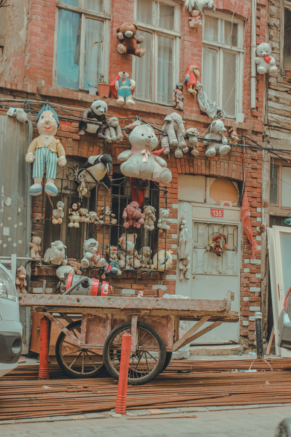 brown wooden cart with white and red bird on top