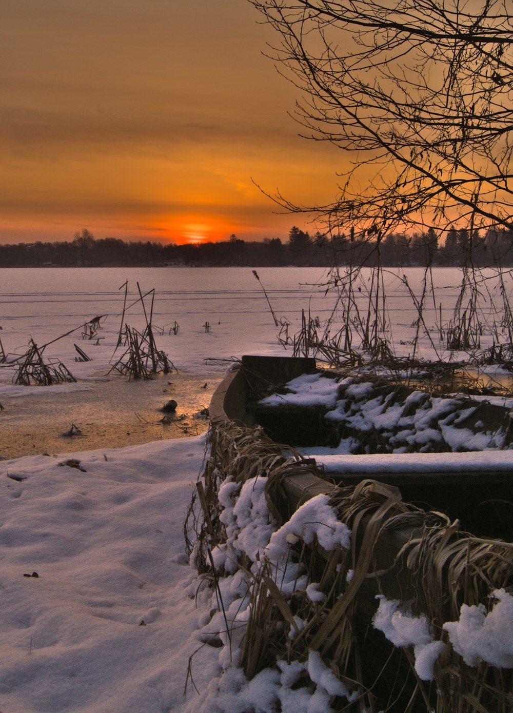 snow covered field during sunset