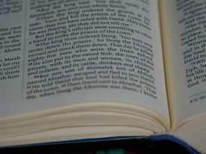 A close-up of a hand flipping through pages of a well-used study guide.