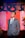 man in gray suit standing near red curtain