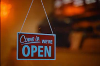 The front door of a cozy office with a clear 9 to 5 sign.