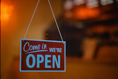 The front door of a cozy office with a clear 9 to 5 sign.