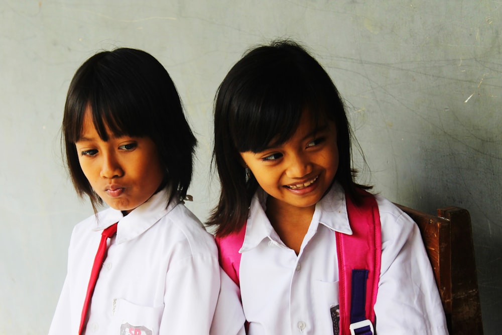 2 women in white and red school uniform