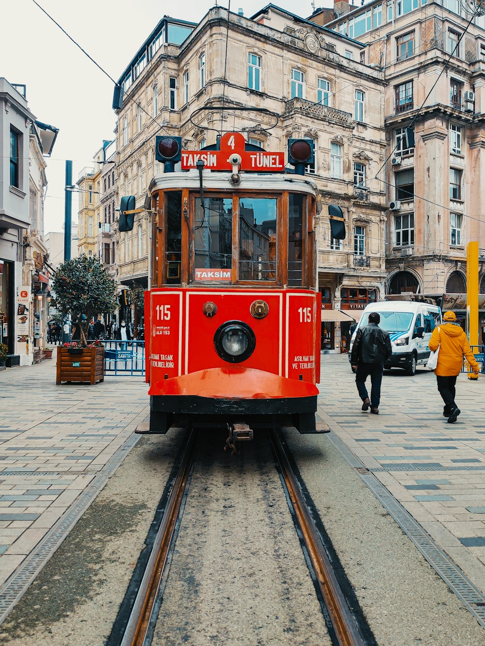 red and white tram on the street