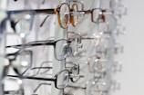 silver framed eyeglasses on clear glass