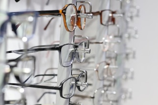 silver framed eyeglasses on clear glass