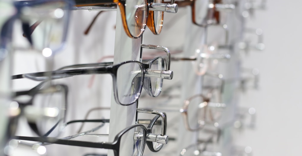 silver framed eyeglasses on clear glass