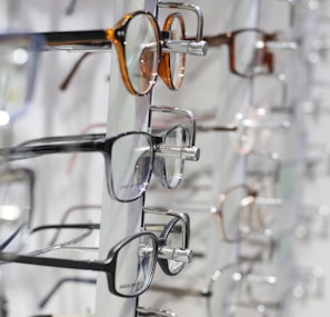 silver framed eyeglasses on clear glass