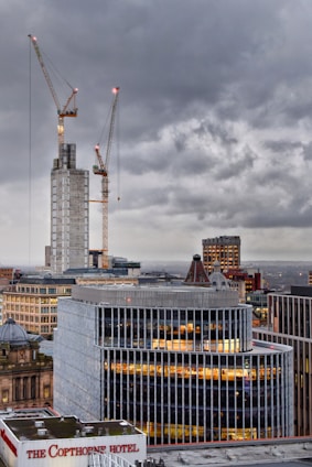 high rise buildings under white clouds during daytime