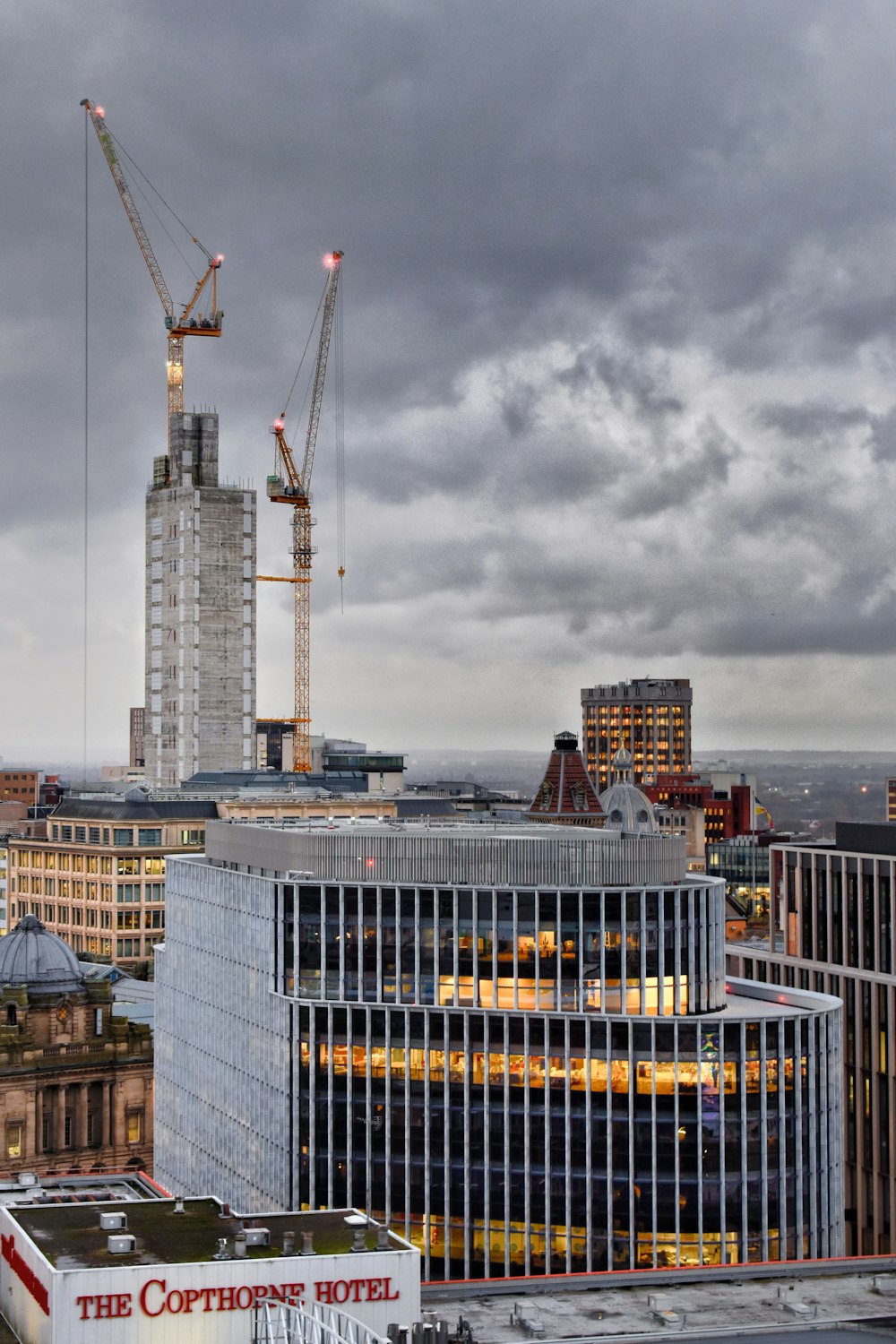 high rise buildings under white clouds during daytime