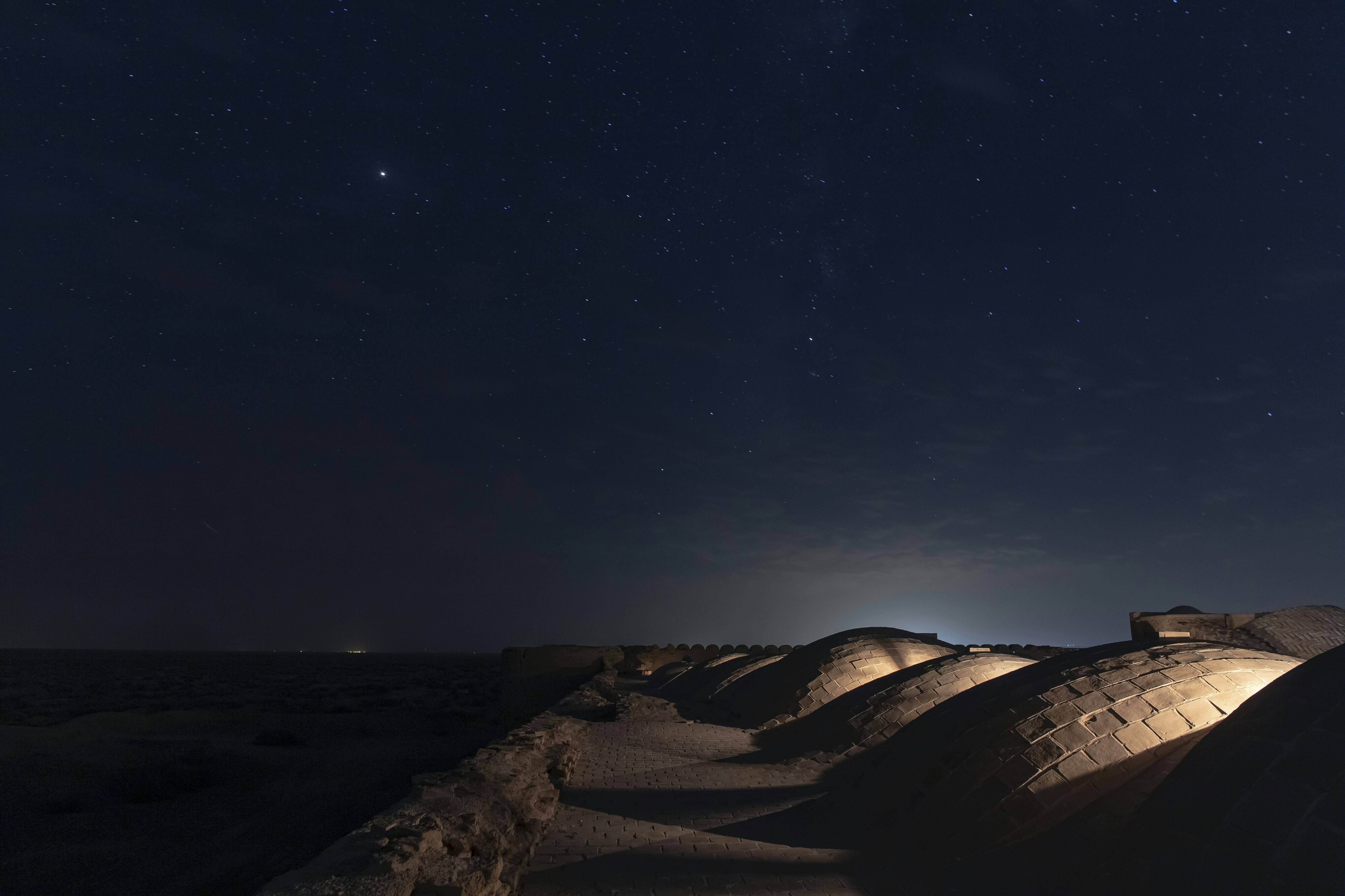 brown sand under blue sky during night time, Deir-e Gachin Caravansarai is one of the greatest caravansarais of Iran which is located in the center of Kavir National Park.
