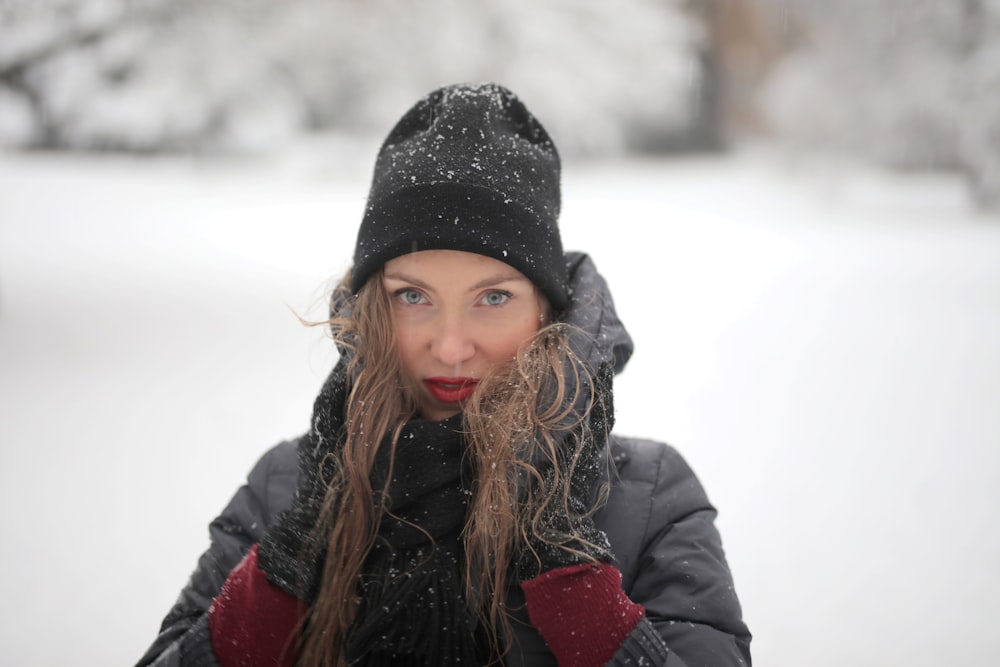 woman in black knit cap and black jacket