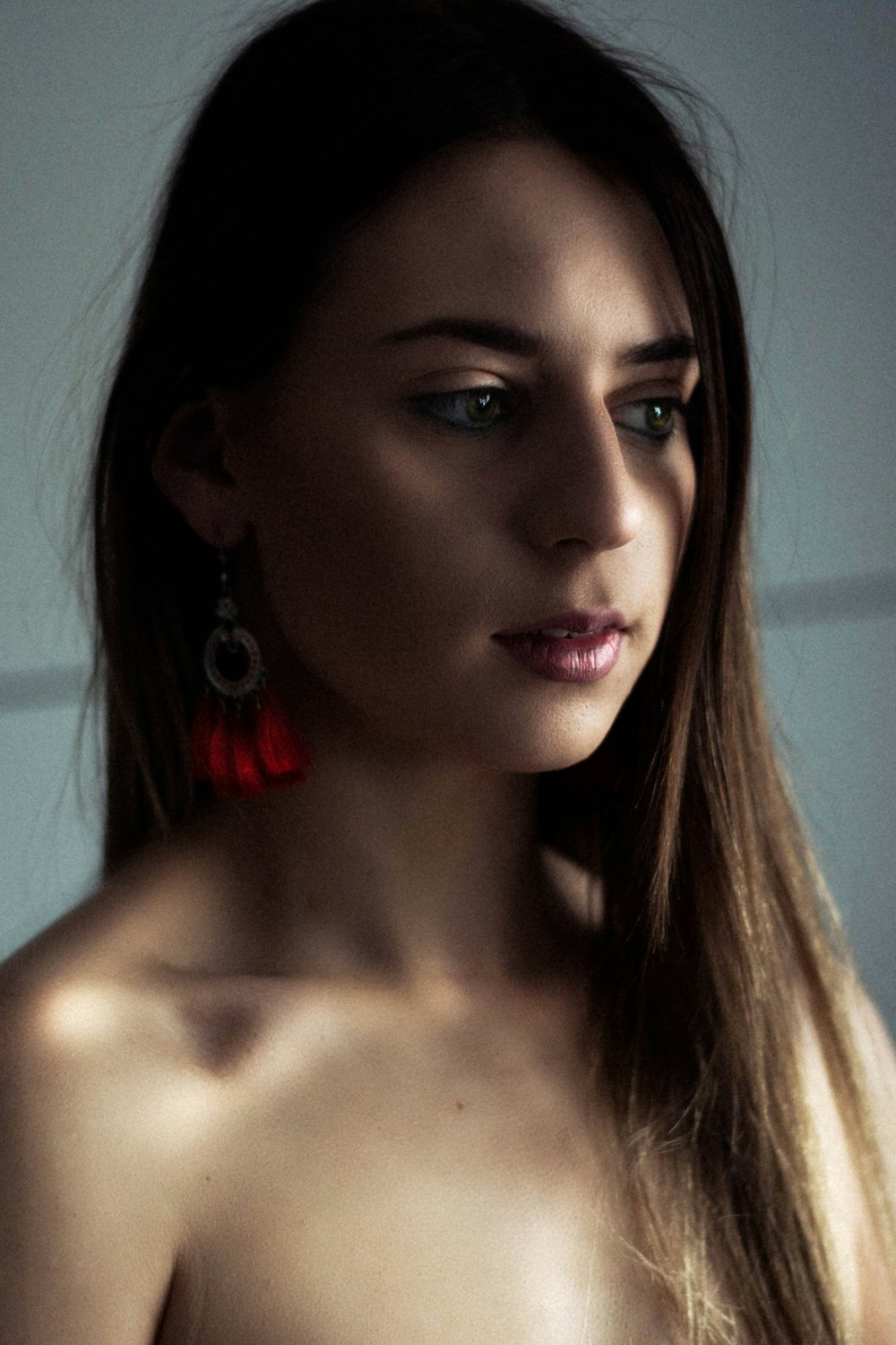 woman with red lipstick and silver earrings