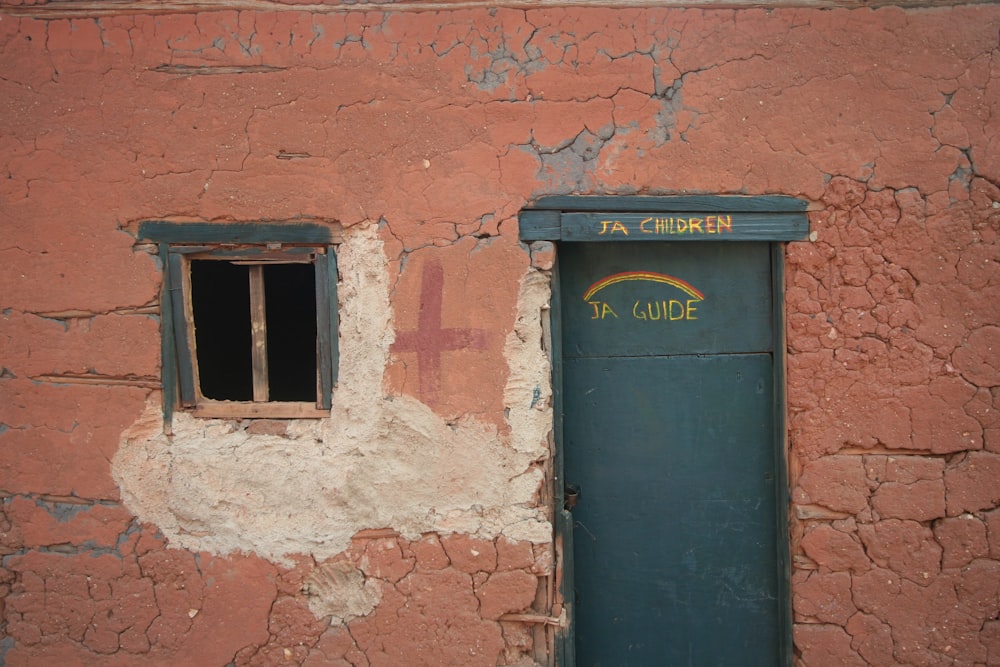 black wooden door on brown brick wall