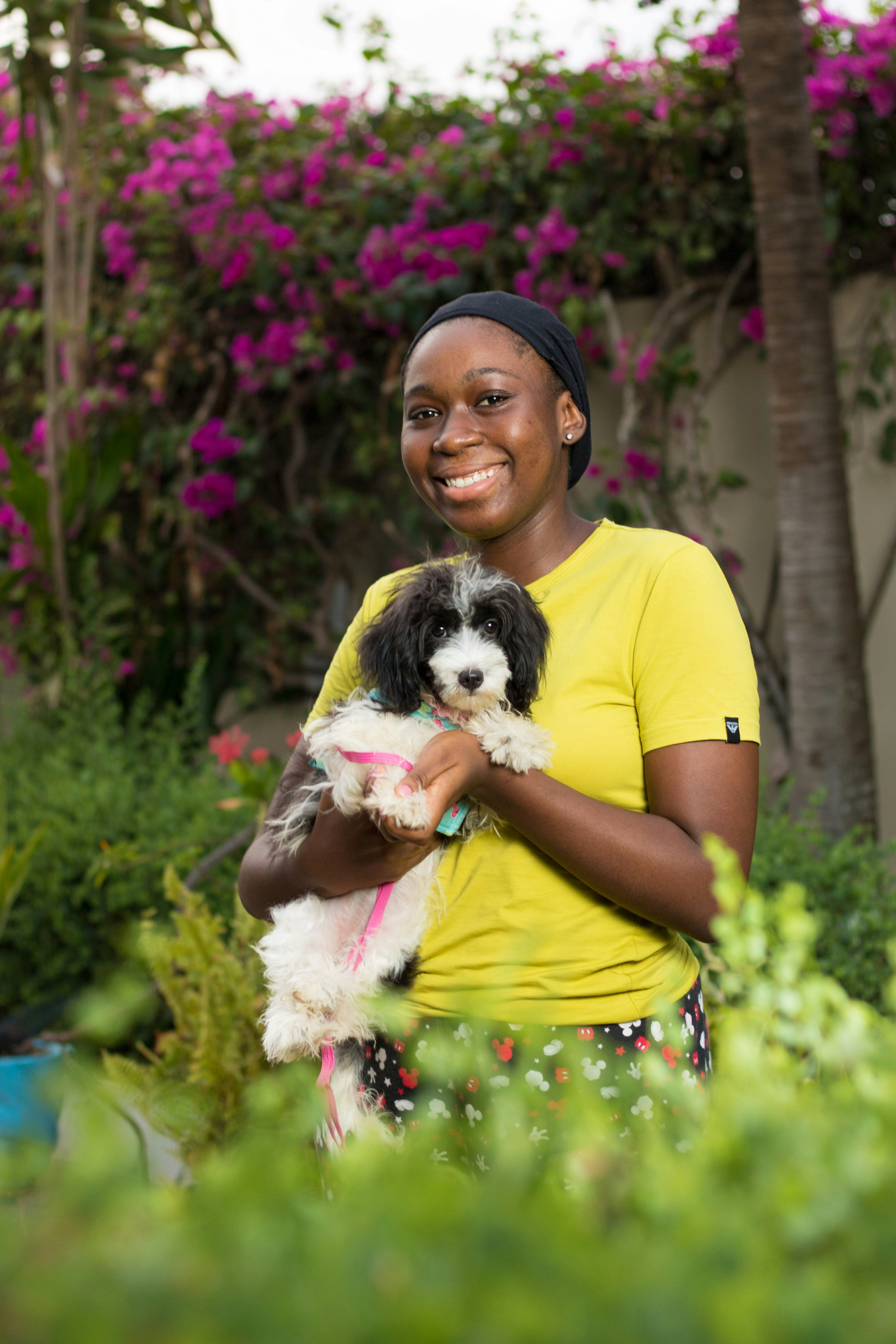Staff member affectionately holding an adopted dog