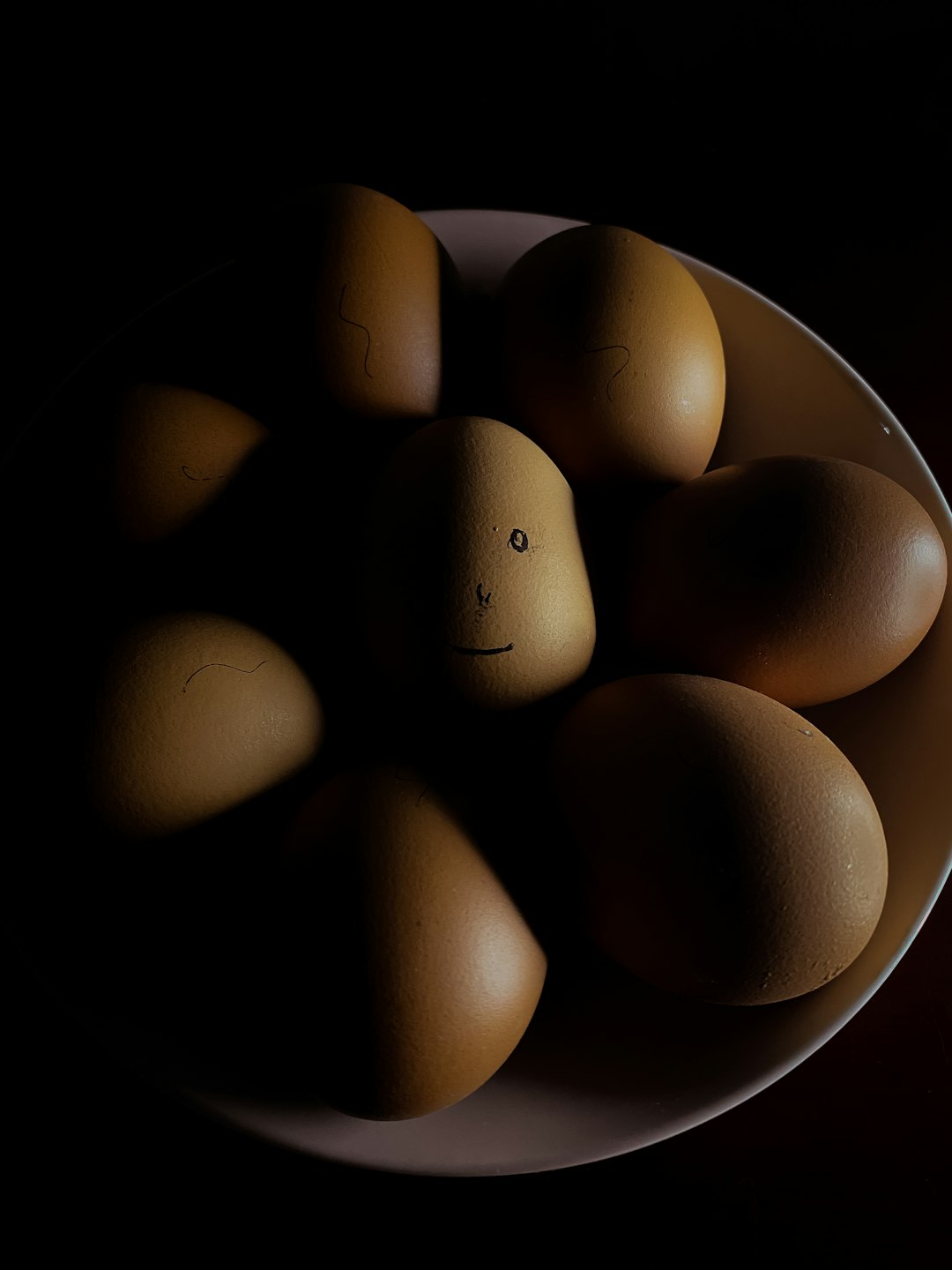 brown egg on white ceramic bowl