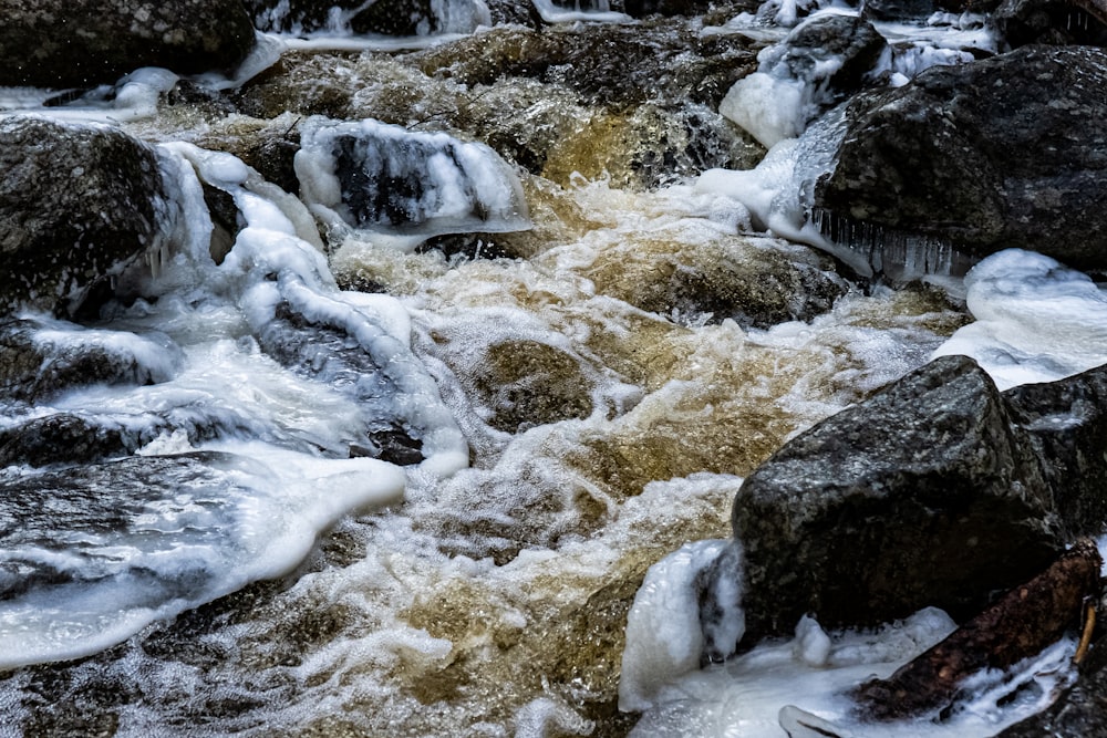 white and gray rock formation on body of water during daytime