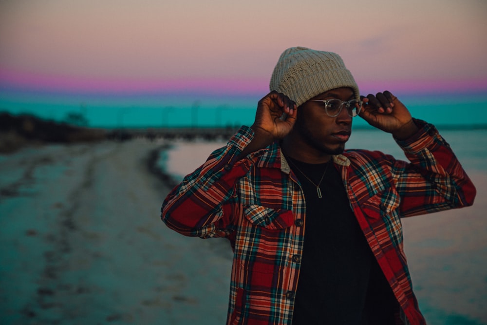 man in red and black plaid button up shirt wearing gray knit cap