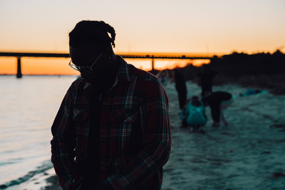 man in black and white plaid dress shirt wearing black sunglasses