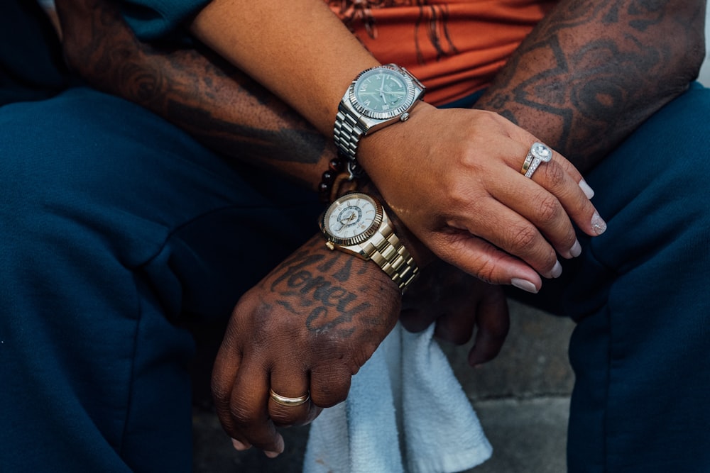 person wearing silver and gold chronograph watch