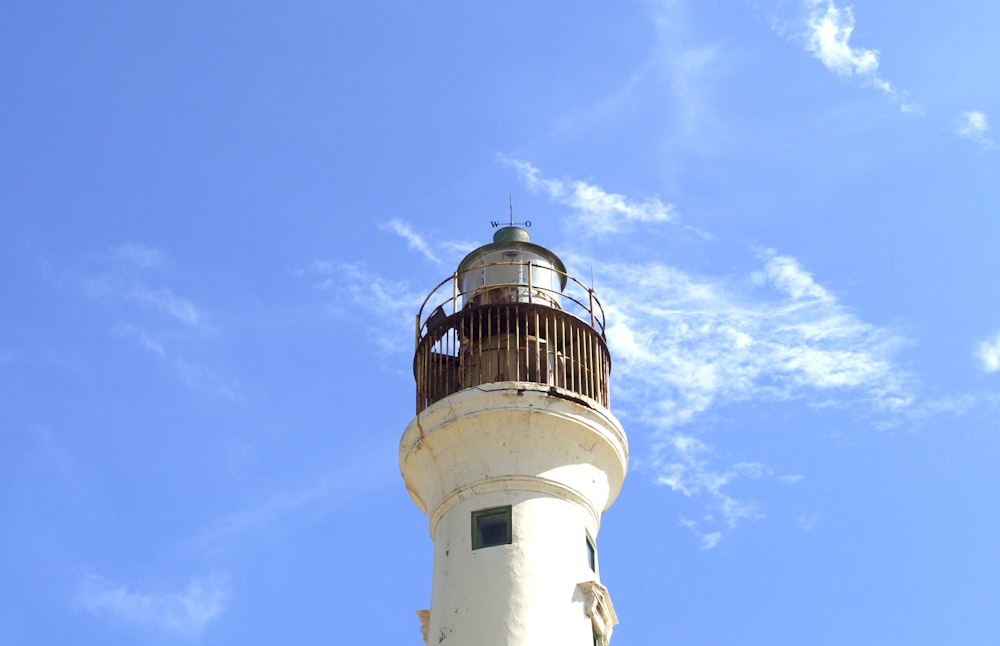 white concrete lighthouse under blue sky during daytime