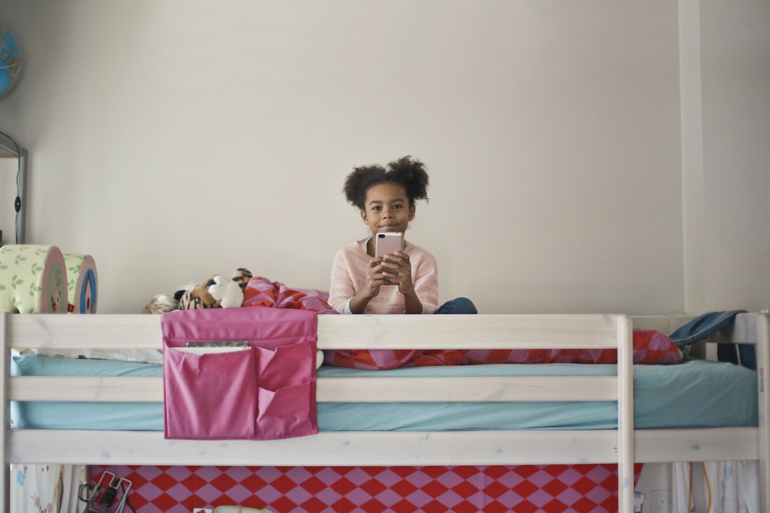 woman in yellow long sleeve shirt sitting on bed