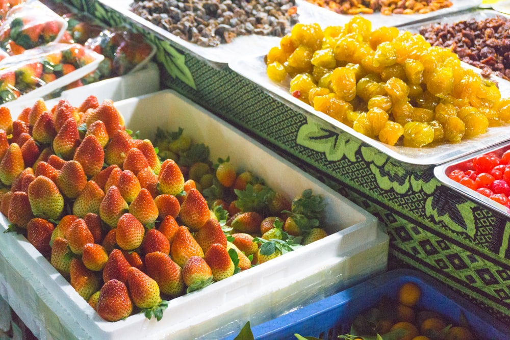 fraises et raisins sur récipient en plastique blanc