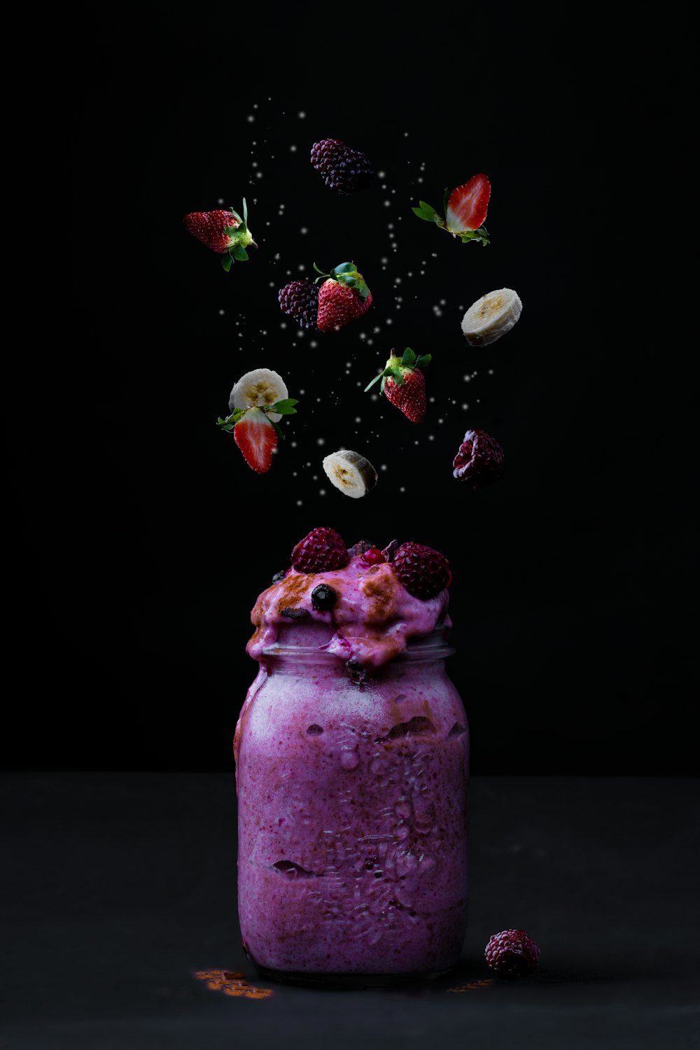 clear glass jar with red and green fruits